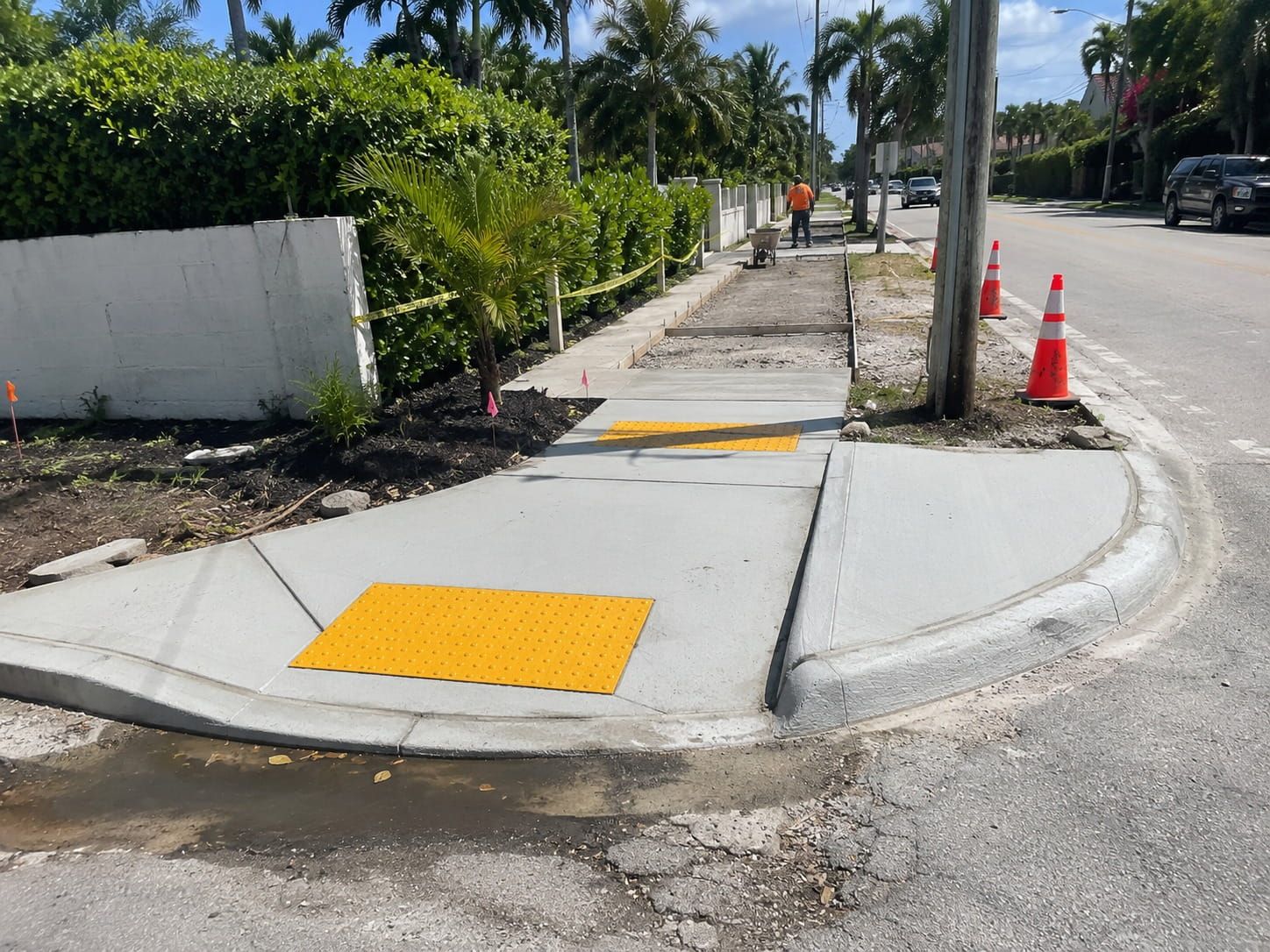 newly poured ADA curb ramp with detectable warning surface on a Miami sidewalk