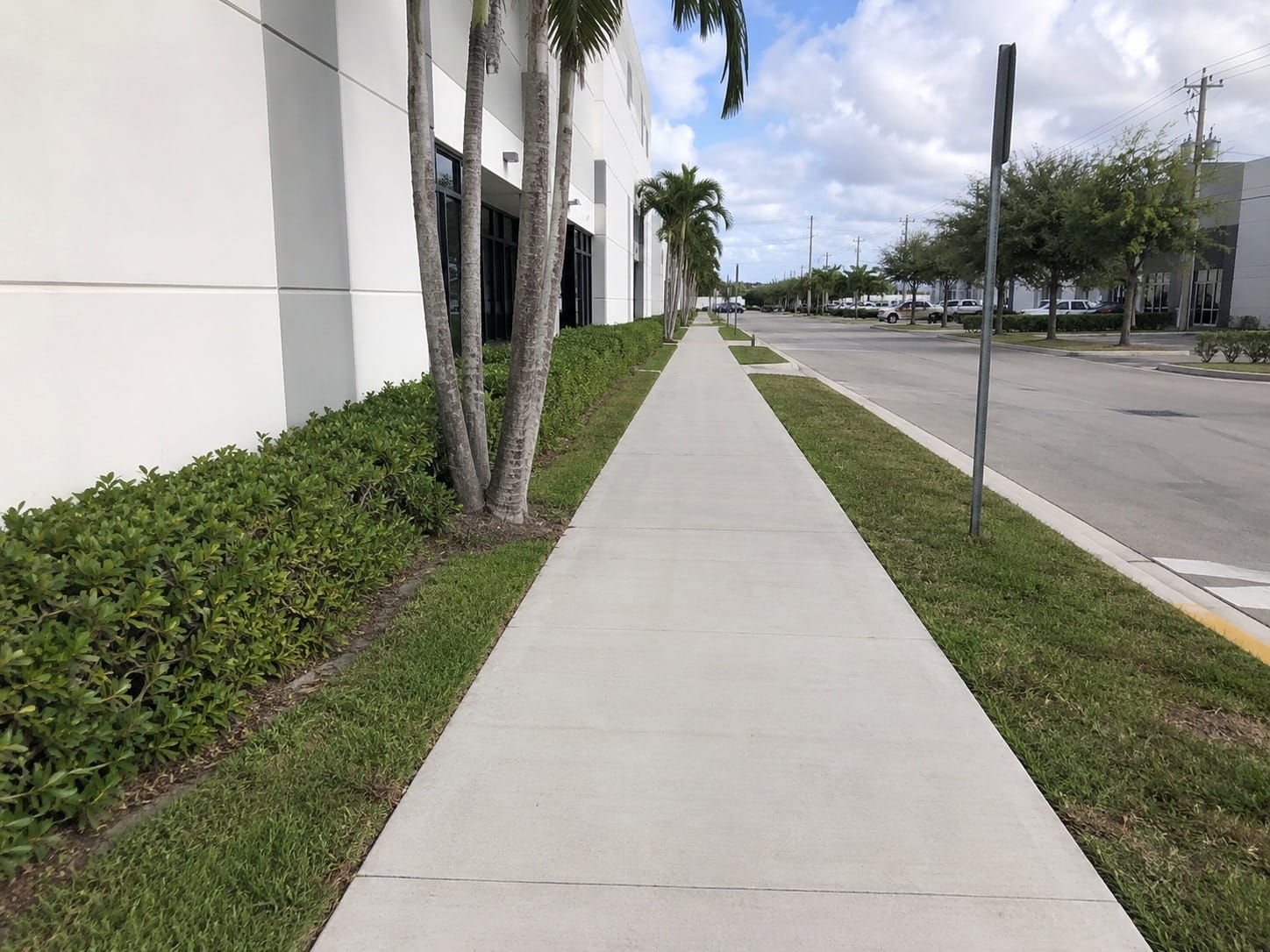 concrete sidewalk along a Miami office park